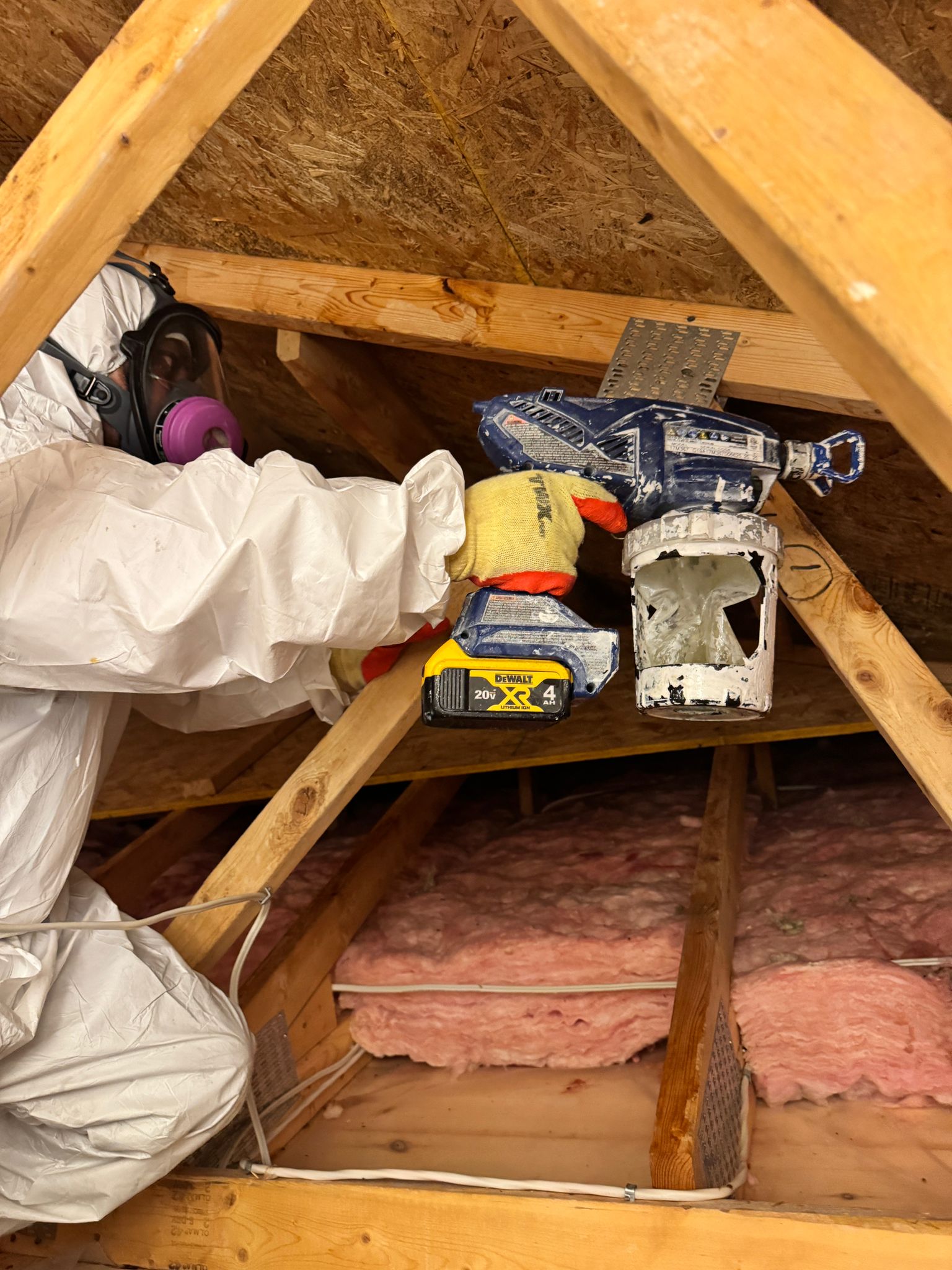 IICRC certified mold remediation technician in full PPE working inside a Toronto attic — Restoration Professionals