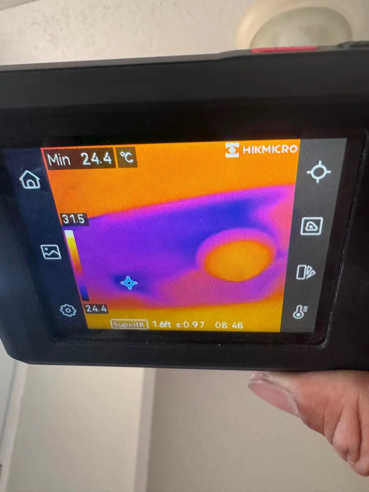 Thermal imaging camera detecting hidden moisture in a Scarborough basement during water damage inspection